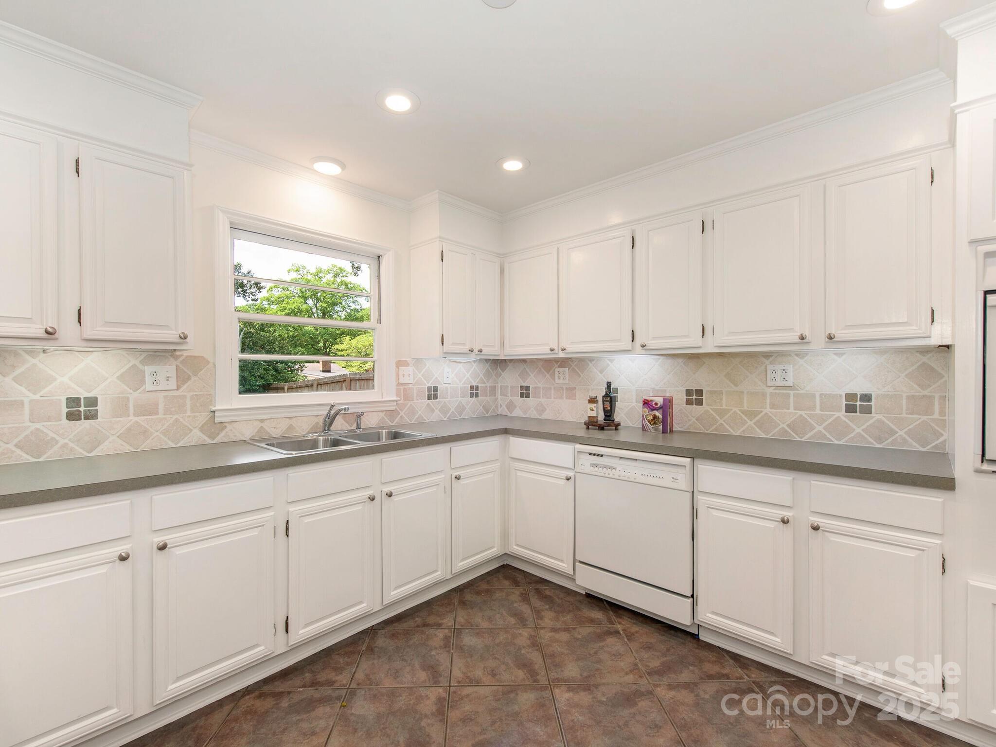 1422 Burnley Road Charlotte, NC 28210 - Photo 9 of 29 a kitchen with sink cabinets and window