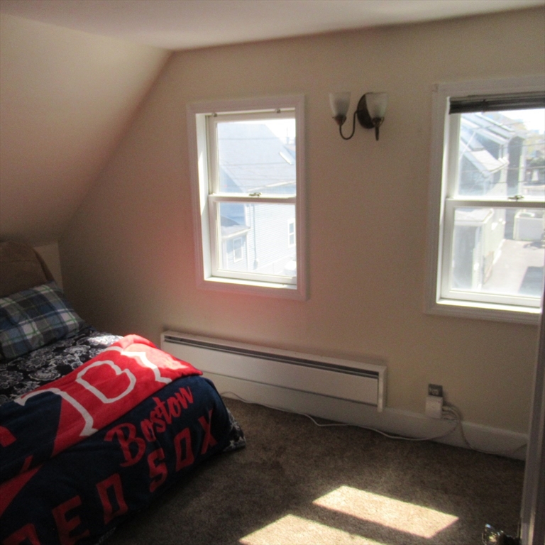 29 Villa Avenue Everett, MA 02149 - Photo 16 of 16 a bedroom with a bed and a window