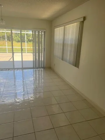 a view of an empty room and a window