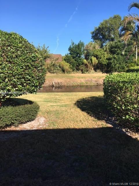 135 Brier Circle Jupiter, FL 33458 - Photo 3 of 14 a view of a lake from a yard