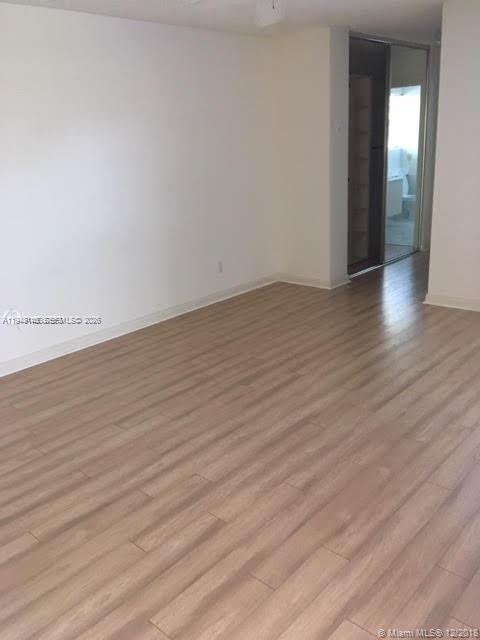 135 Brier Circle Jupiter, FL 33458 - Photo 5 of 14 wooden floor in a hall with an empty room