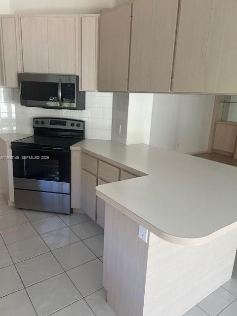 135 Brier Circle Jupiter, FL 33458 - Photo 7 of 14 a kitchen with a sink a stove and cabinets