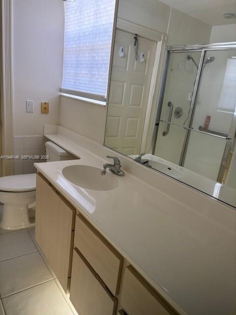 135 Brier Circle Jupiter, FL 33458 - Photo 9 of 14 a bathroom with a sink a toilet and a mirror