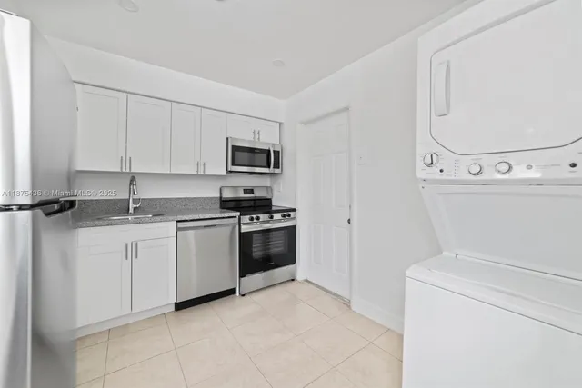 a kitchen with a sink and a stove top oven
