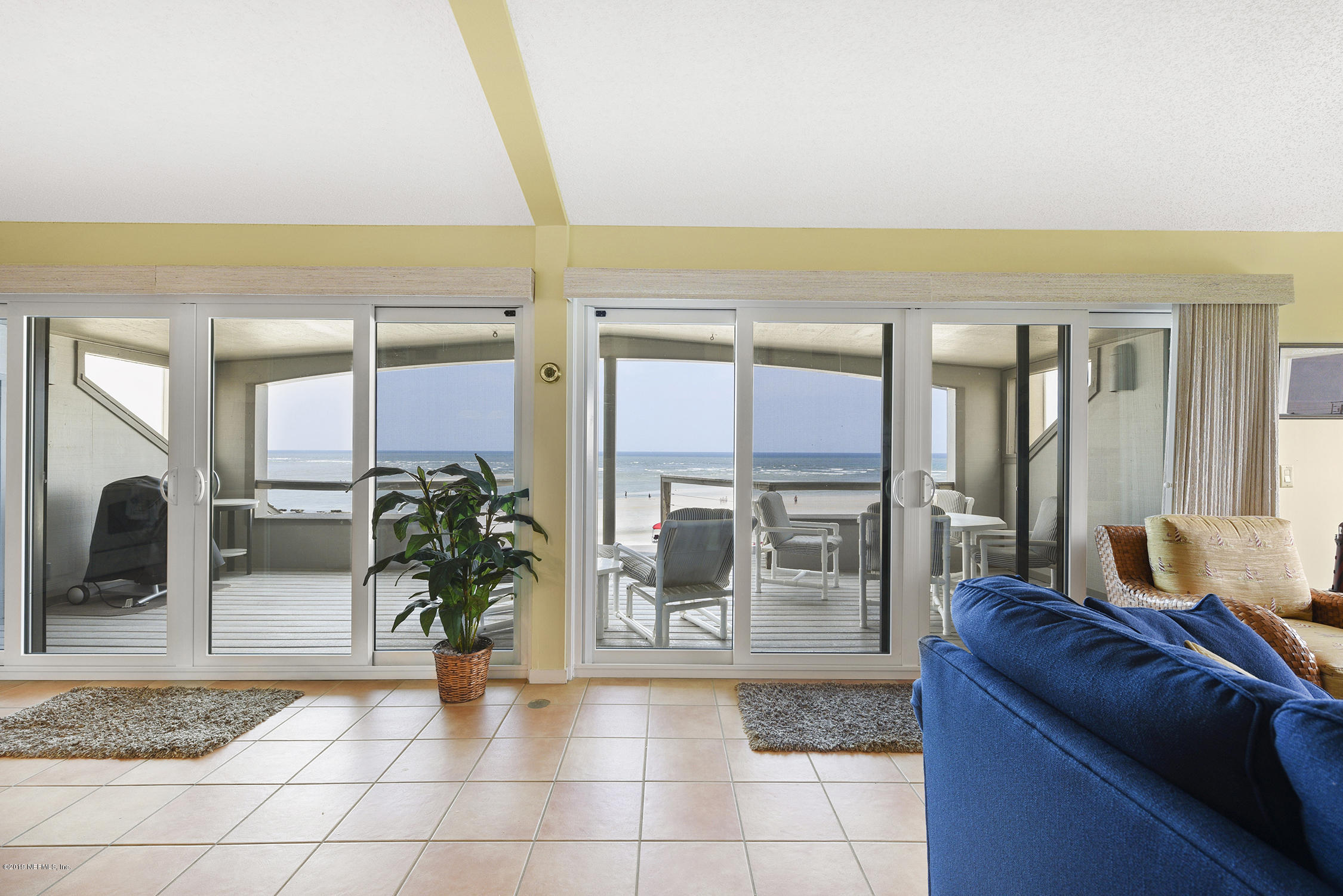 8850 Old A1A, Unit 9 St. Augustine, FL 32080 - Photo 11 of 37 a living room with furniture and a floor to ceiling window