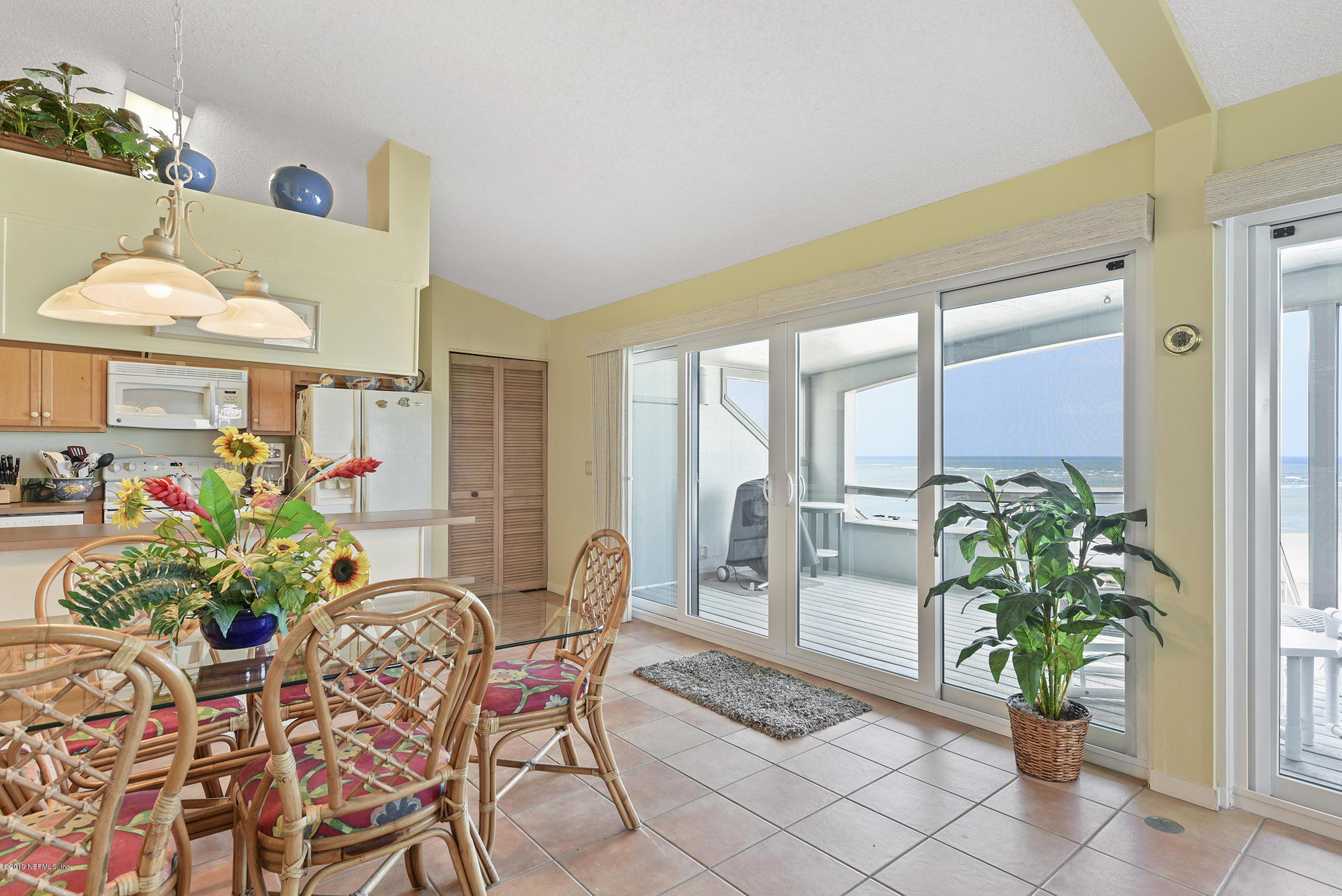 8850 Old A1A, Unit 9 St. Augustine, FL 32080 - Photo 14 of 37 a dining room filled with furniture and a potted plant