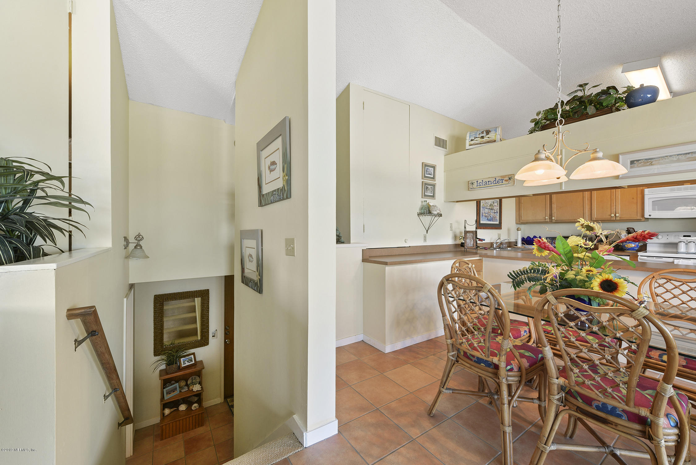 8850 Old A1A, Unit 9 St. Augustine, FL 32080 - Photo 22 of 37 a dining room filled with furniture and a chandelier
