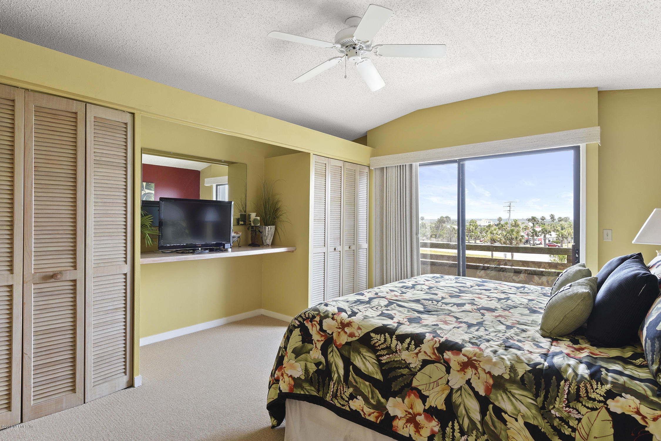 8850 Old A1A, Unit 9 St. Augustine, FL 32080 - Photo 23 of 37 a bedroom with a bed and a window