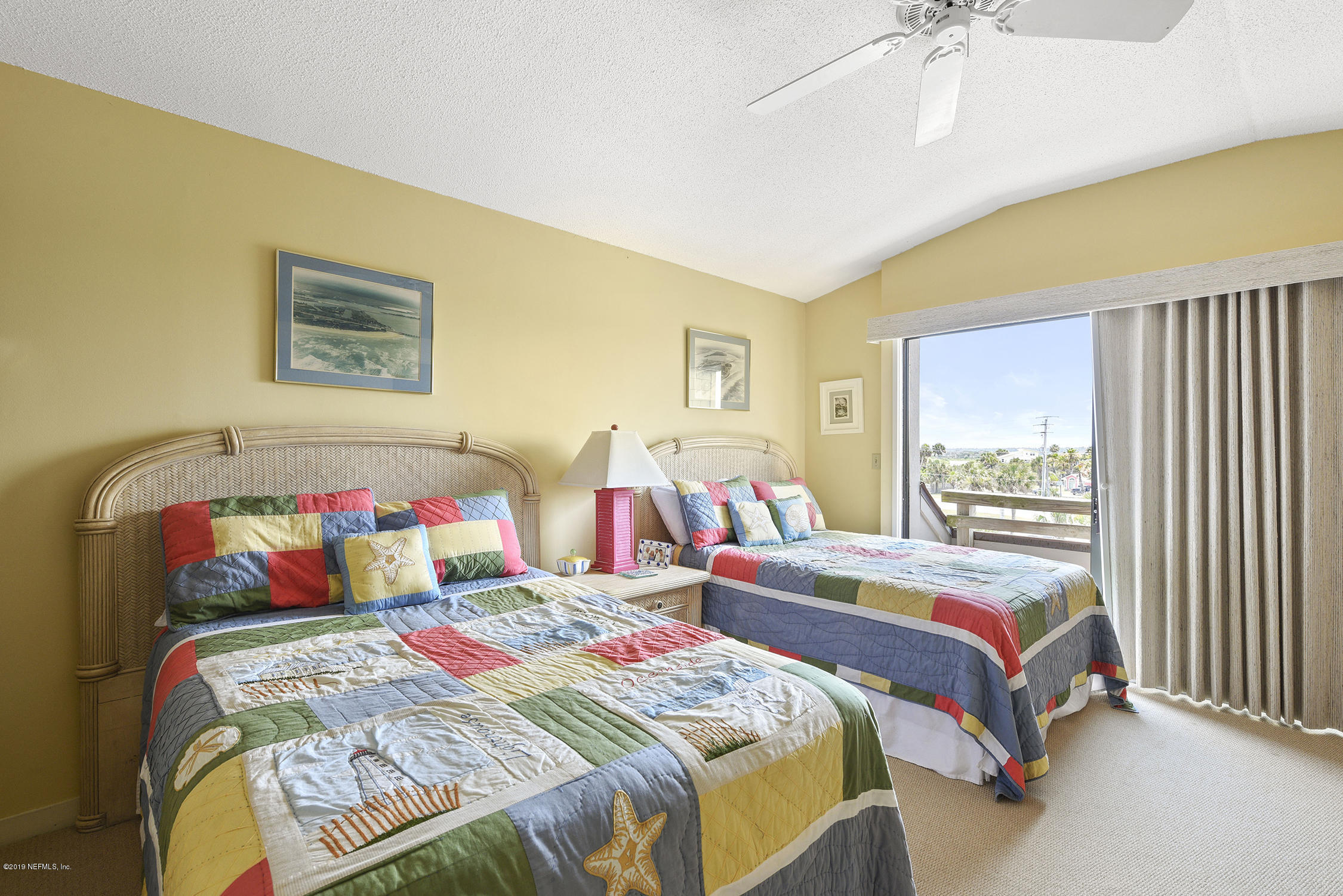 8850 Old A1A, Unit 9 St. Augustine, FL 32080 - Photo 27 of 37 a bedroom with two beds and a dresser next to a window