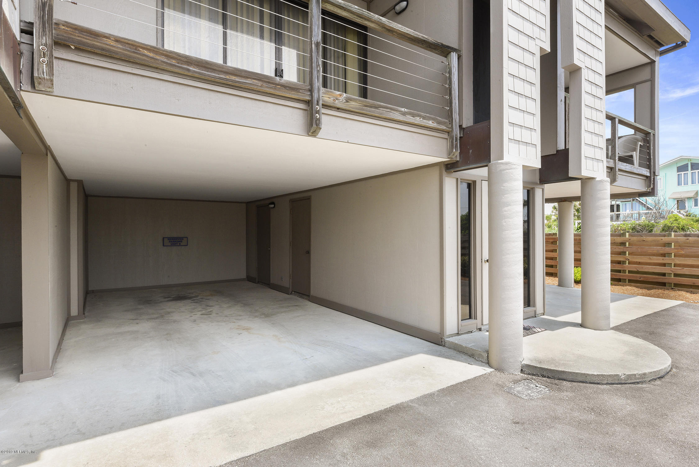 8850 Old A1A, Unit 9 St. Augustine, FL 32080 - Photo 31 of 37 a view of a hallway with a chair and table