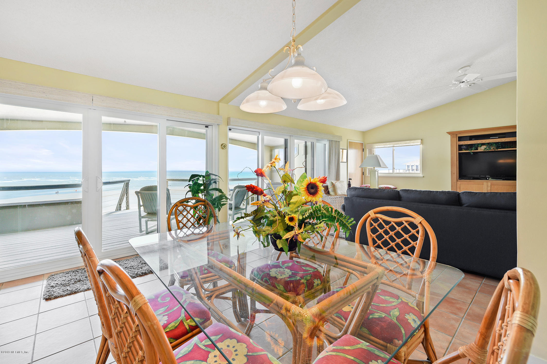 8850 Old A1A, Unit 9 St. Augustine, FL 32080 - Photo 10 of 37 a view of a dining room with furniture and a chandelier