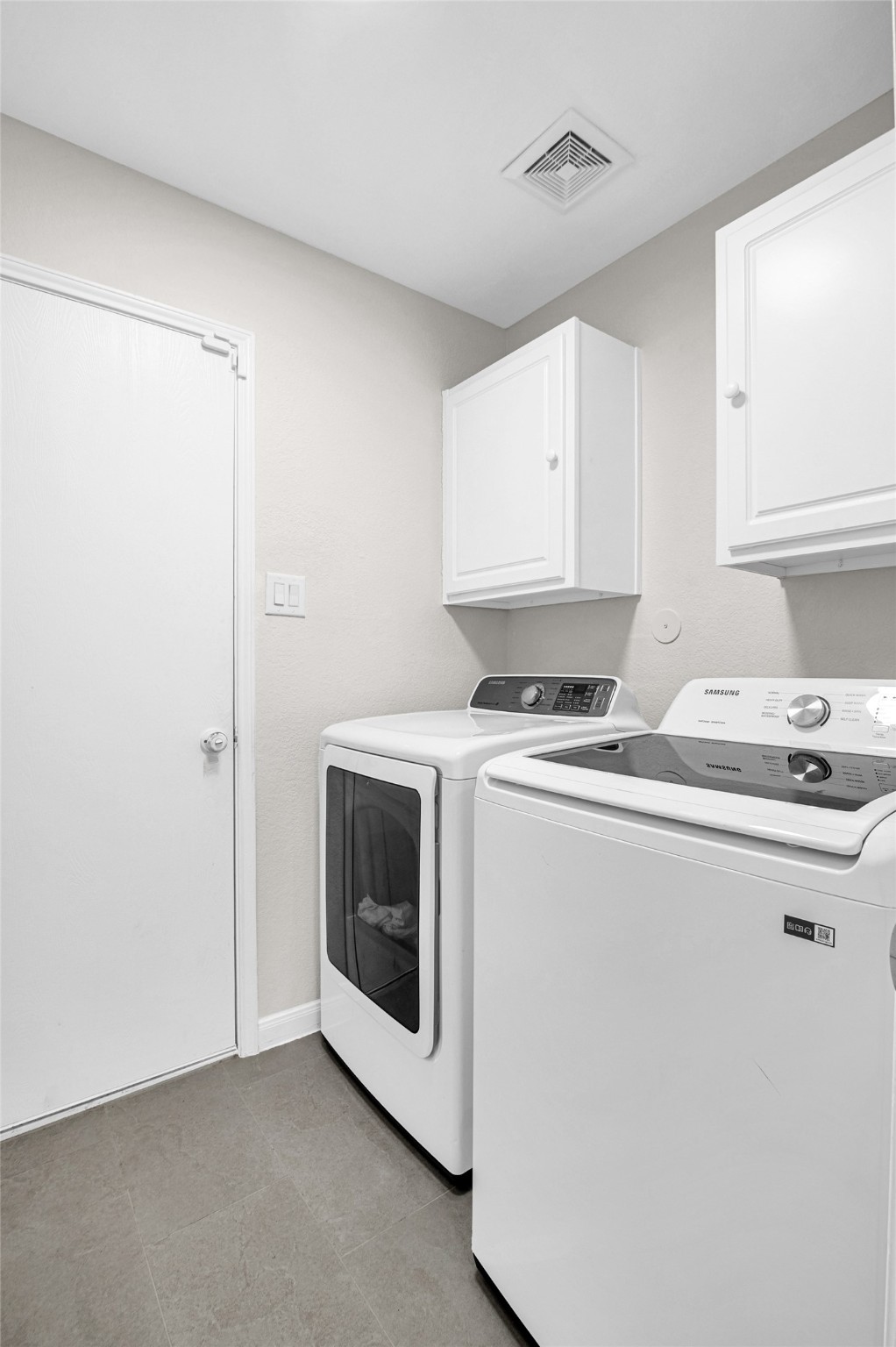 29514 North Legends Bend Drive Spring, TX 77386 - Photo 16 of 19 The spacious laundry room includes a new washer and dryer, along with five-tier shelving and overhead cabinets for organized, efficient living.
