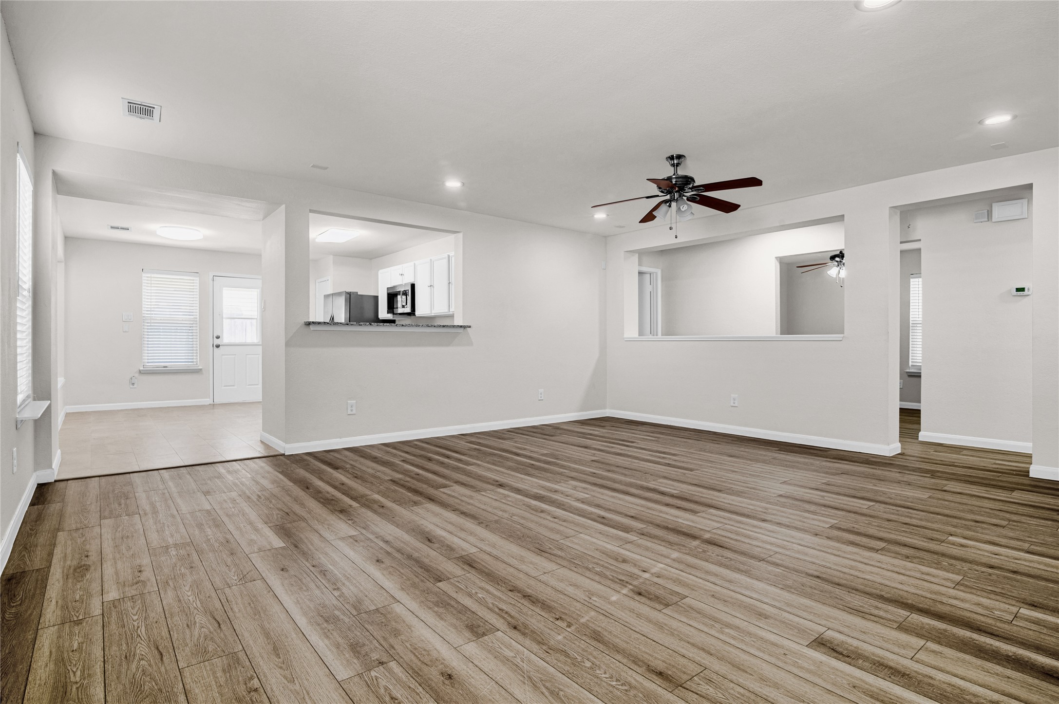 29514 North Legends Bend Drive Spring, TX 77386 - Photo 4 of 19 The spacious living room is bright and inviting, featuring an open, airy feel with seamless flow into the kitchen—perfect for gathering, relaxing, and entertaining.