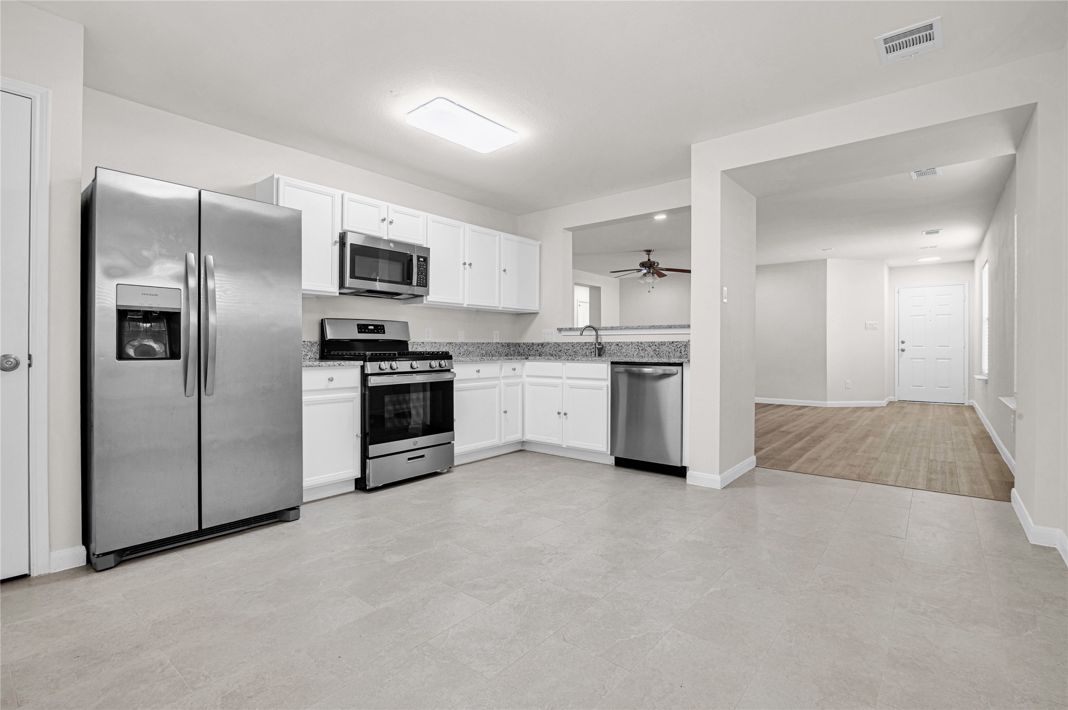 29514 North Legends Bend Drive Spring, TX 77386 - Photo 6 of 19 The open kitchen is bright and functional, featuring a gas range with open counter space, flowing effortlessly into the living area for easy everyday living and entertaining.