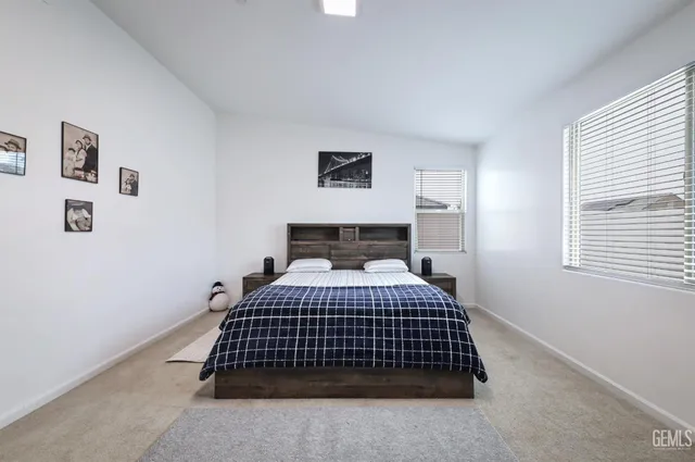 a bedroom with a bed and window