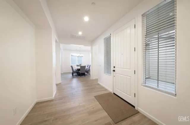 a view of a hallway with a livingroom and a livingroom with furniture