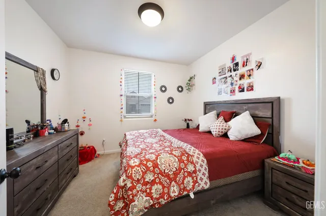 a bedroom with a bed and a dresser in it