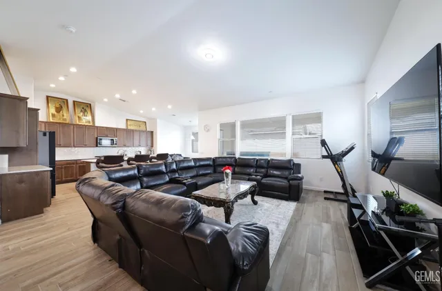 a living room with furniture windows and a wooden floor