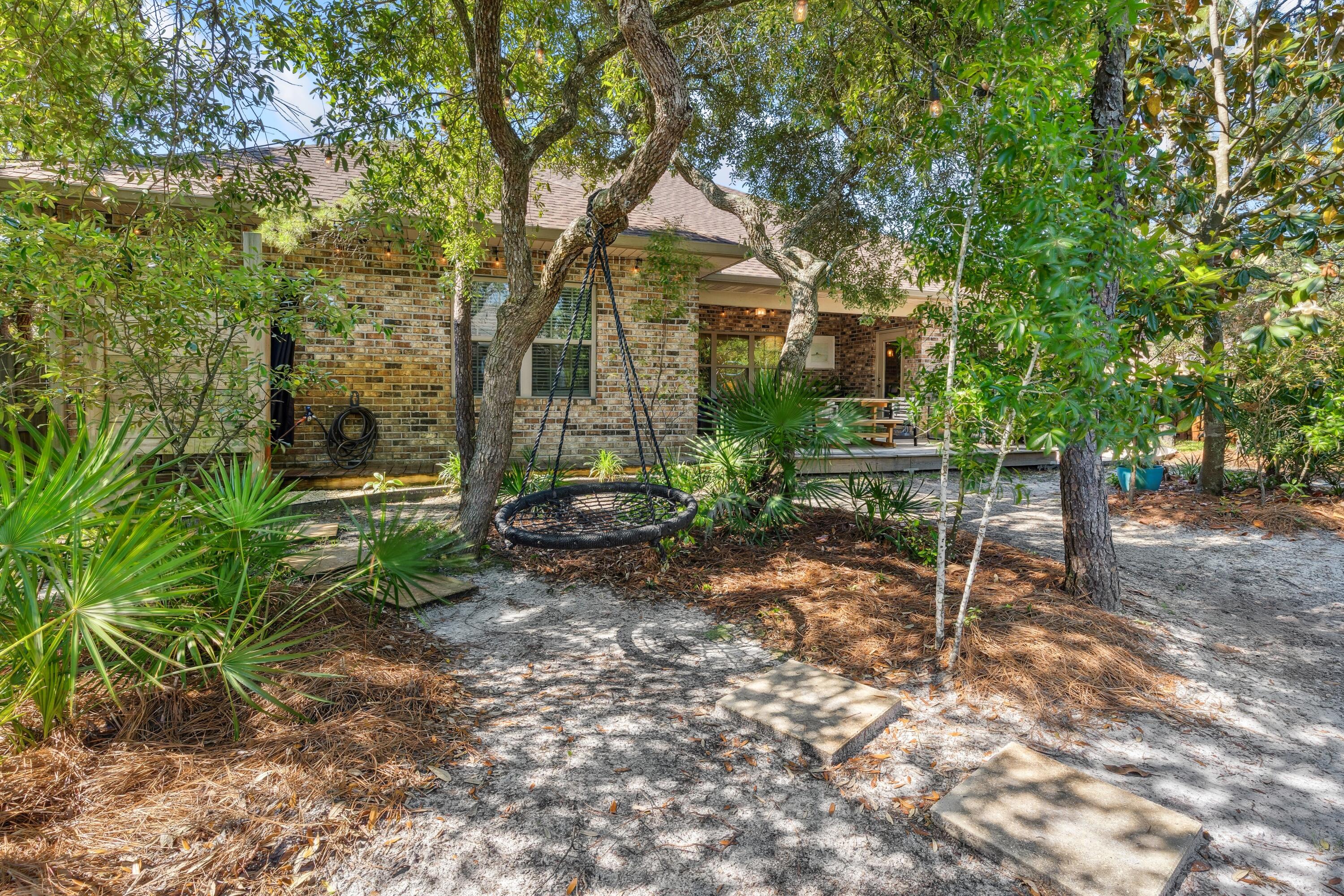 209 Forest Park Drive Santa Rosa Beach, FL 32459 - Photo 36 of 49 a view of a house with a yard and sitting area