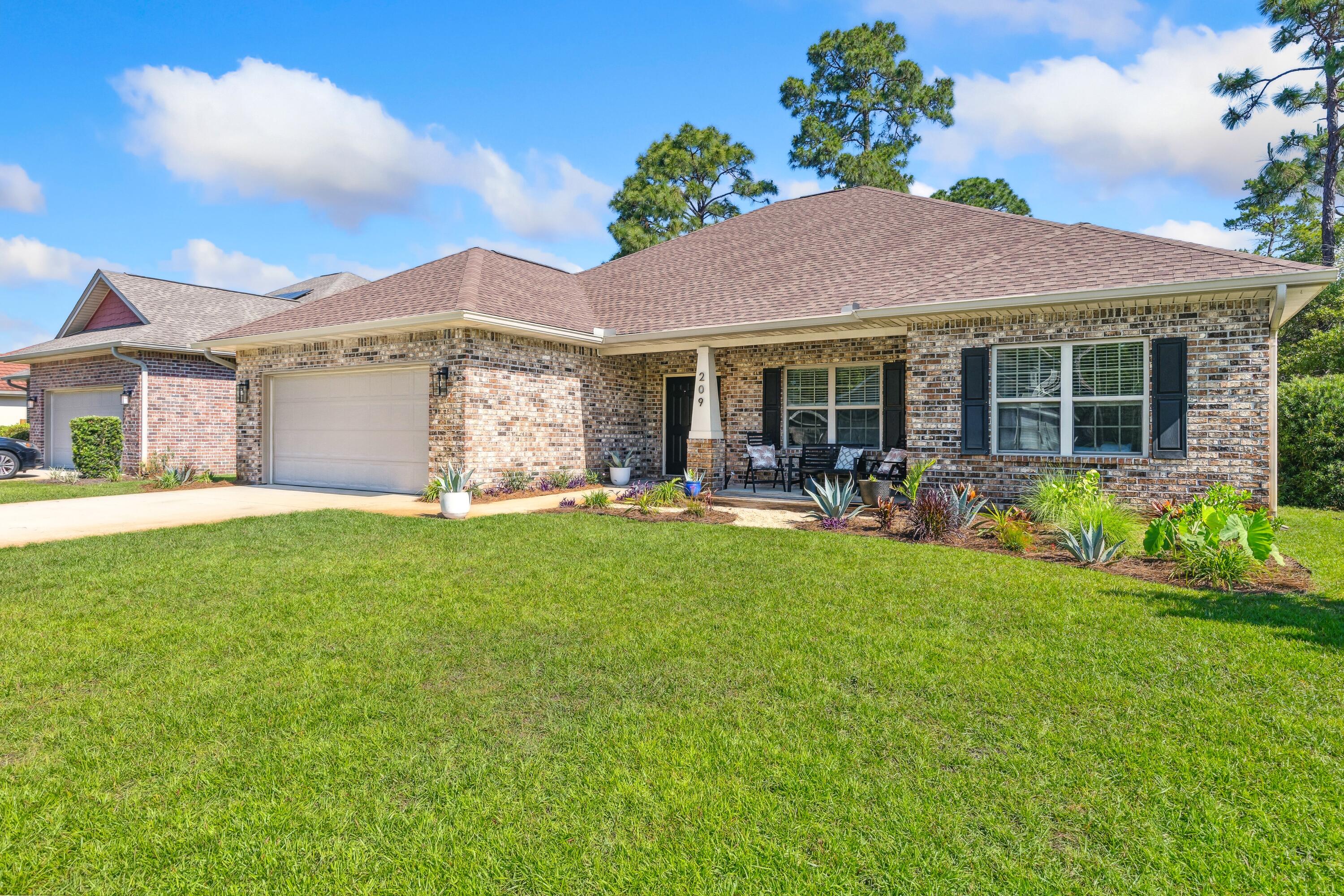 209 Forest Park Drive Santa Rosa Beach, FL 32459 - Photo 40 of 49 a front view of house with yard and outdoor seating
