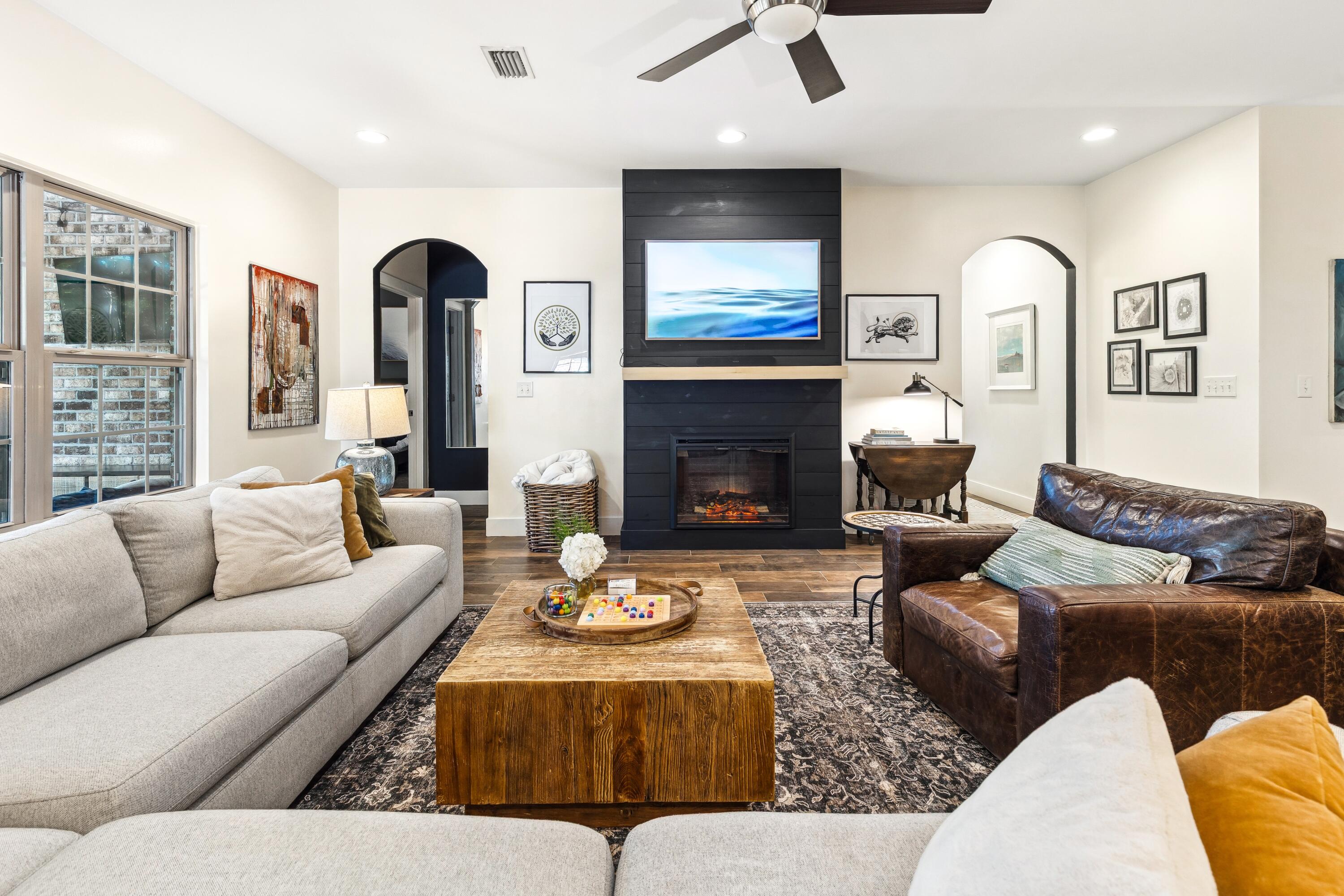 209 Forest Park Drive Santa Rosa Beach, FL 32459 - Photo 4 of 49 a living room with furniture kitchen view and a fireplace