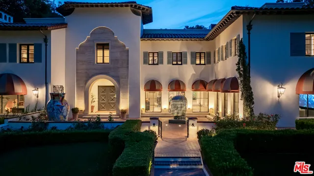 a front view of multiple houses with outdoor seating