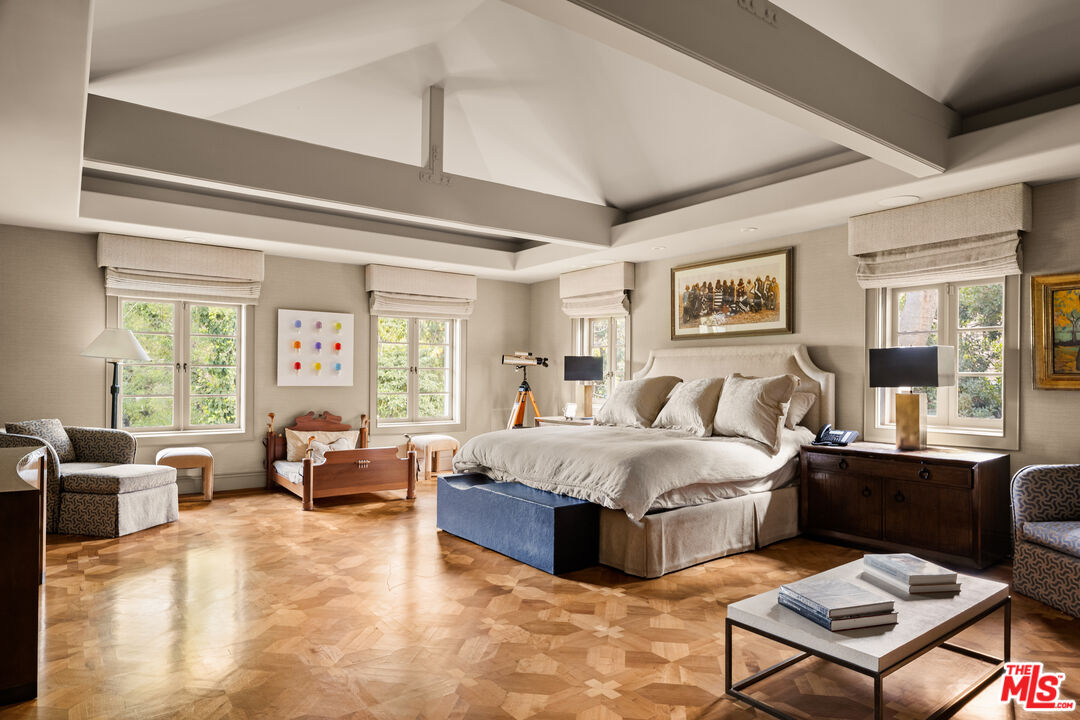 4009 Valley Meadow Road Encino, CA 91436 - Photo 19 of 32 a spacious bedroom with a bed and glass window