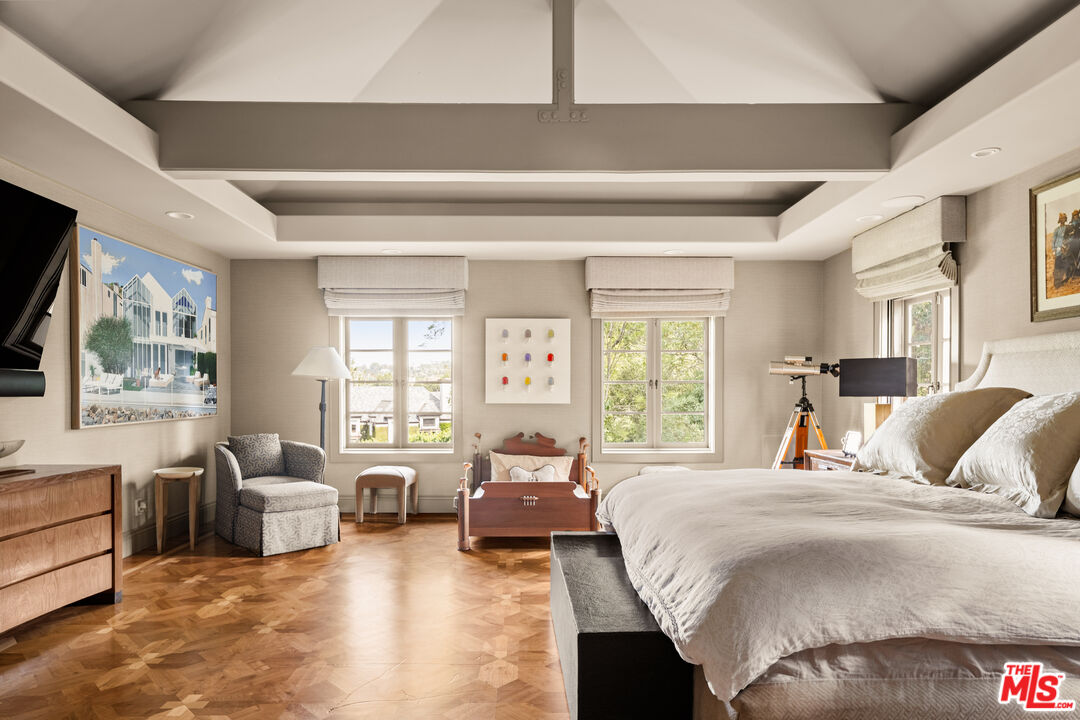 4009 Valley Meadow Road Encino, CA 91436 - Photo 20 of 32 a bedroom with a large bed couch and a large window