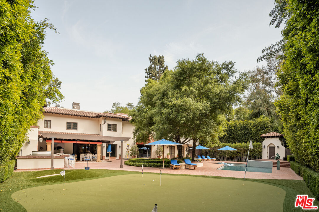 4009 Valley Meadow Road Encino, CA 91436 - Photo 3 of 32 a swimming pool view with a seating space and a garden view