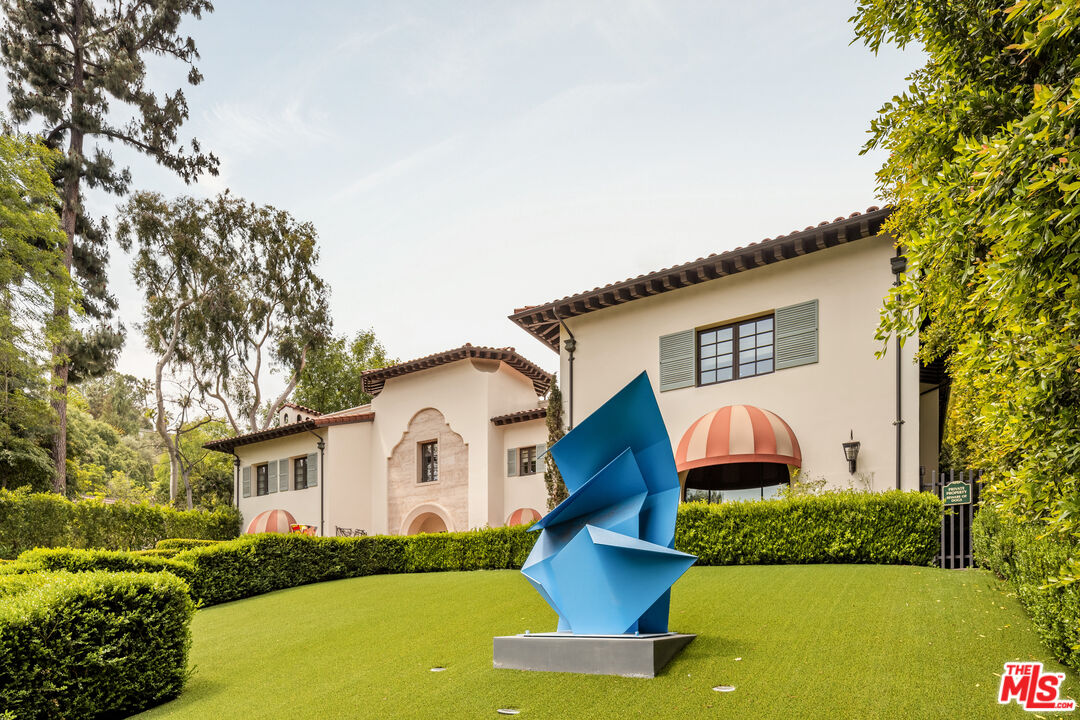 4009 Valley Meadow Road Encino, CA 91436 - Photo 4 of 32 a front view of a house with garden