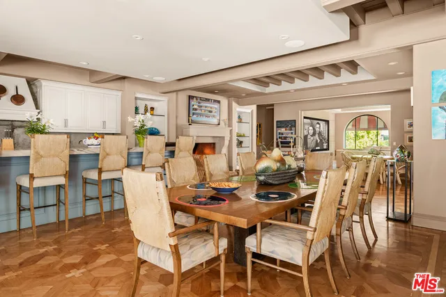 a kitchen with a table chairs refrigerator and cabinets