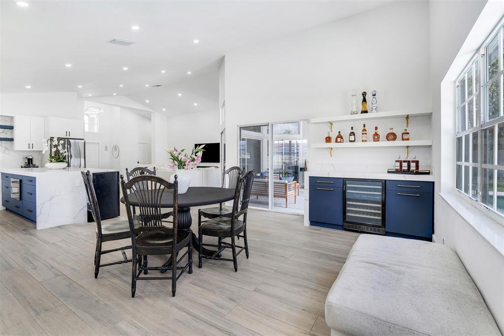 558 Slippery Rock Road Weston, FL 33327 - Photo 11 of 28 a dining hall with stainless steel appliances kitchen island granite countertop a table and chairs