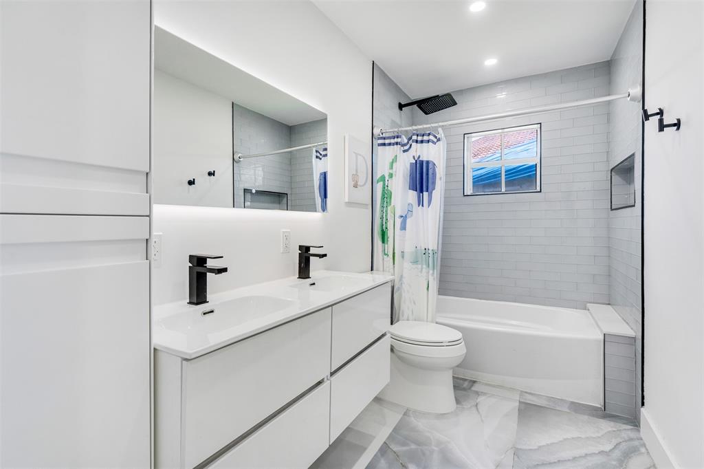 558 Slippery Rock Road Weston, FL 33327 - Photo 14 of 28 a bathroom with a sink toilet tub and shower