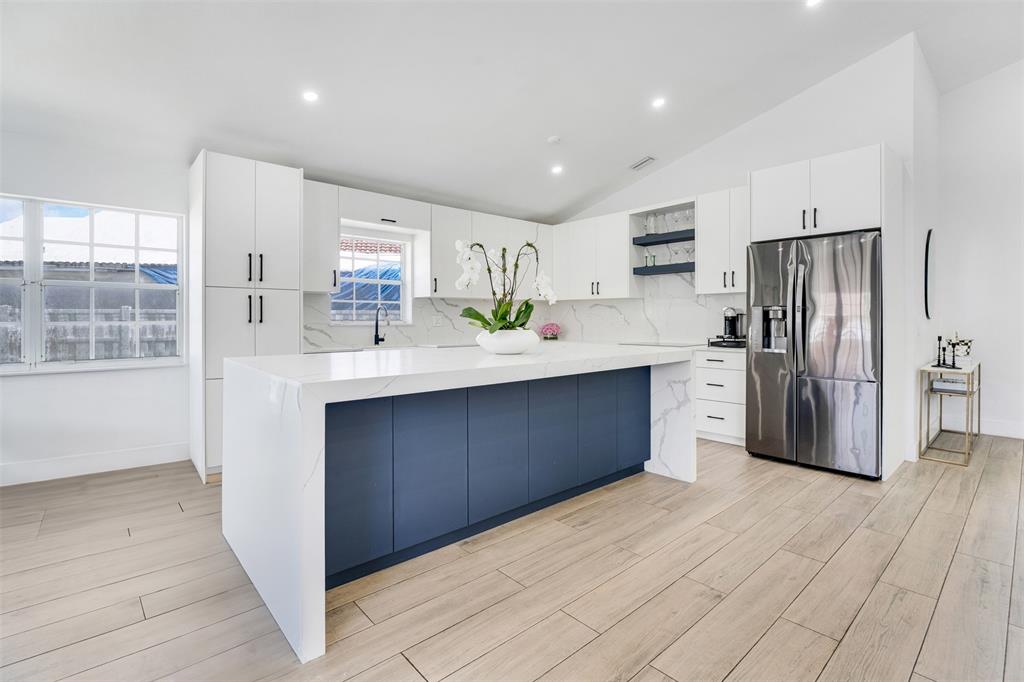 558 Slippery Rock Road Weston, FL 33327 - Photo 2 of 28 a kitchen with stainless steel appliances a sink cabinets and wooden floor
