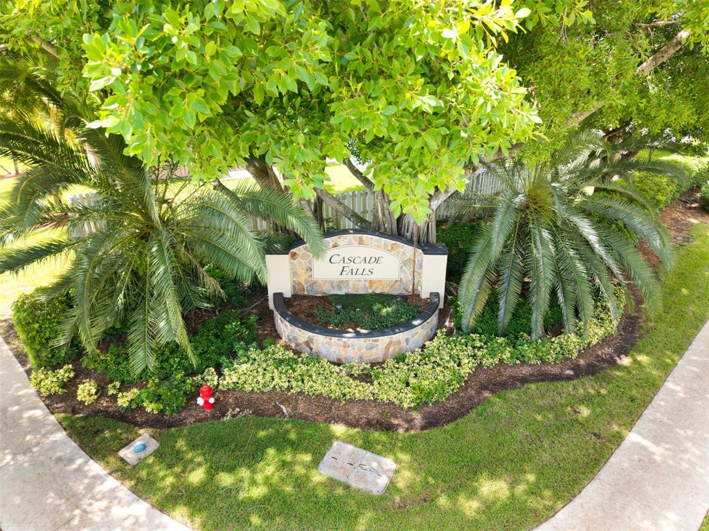 558 Slippery Rock Road Weston, FL 33327 - Photo 26 of 28 a sign that is sitting in the grass near a tree