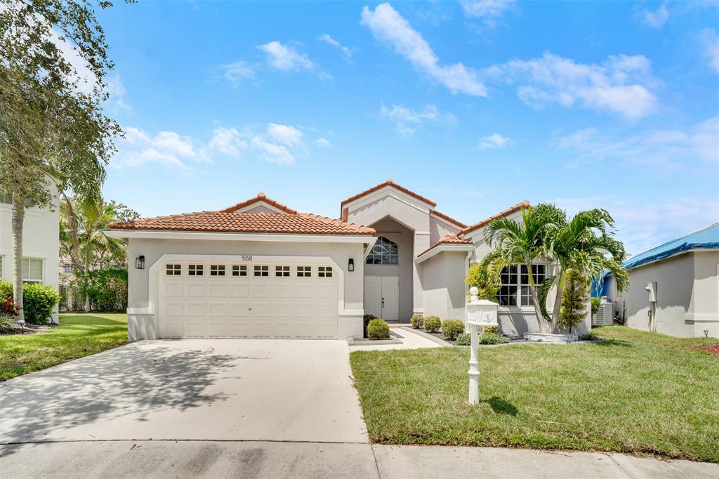 558 Slippery Rock Road Weston, FL 33327 - Photo 27 of 28 a front view of a house with garden
