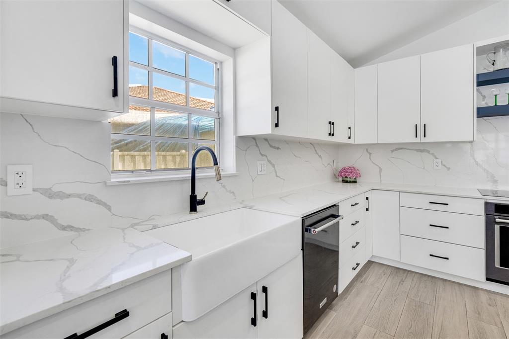 558 Slippery Rock Road Weston, FL 33327 - Photo 3 of 28 a kitchen with cabinets appliances and a sink