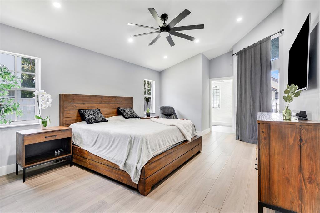 558 Slippery Rock Road Weston, FL 33327 - Photo 8 of 28 a bedroom with a bed and a flat screen tv