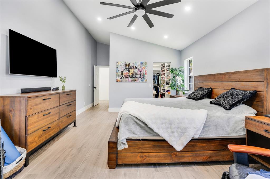 558 Slippery Rock Road Weston, FL 33327 - Photo 9 of 28 a bedroom with a bed and a flat screen tv