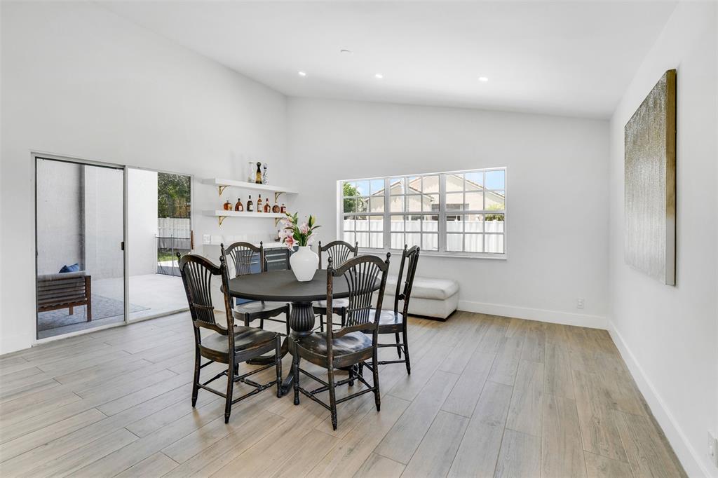 558 Slippery Rock Road Weston, FL 33327 - Photo 10 of 28 a view of a dining room with furniture and wooden floor