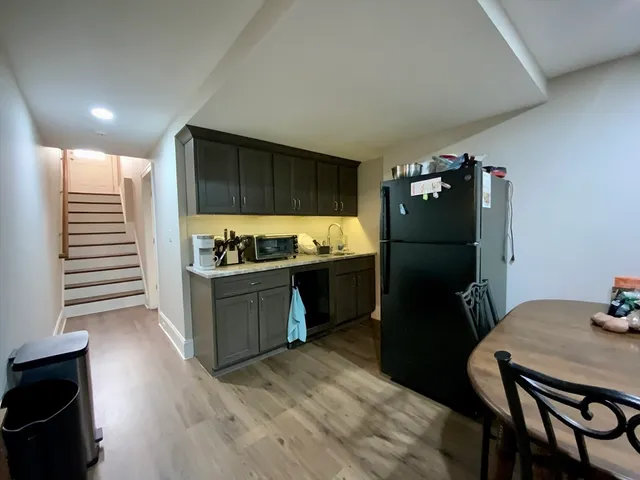 a kitchen with a refrigerator and a stove top oven