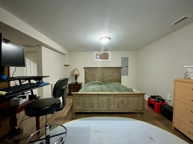 a bedroom with a bed and a chair