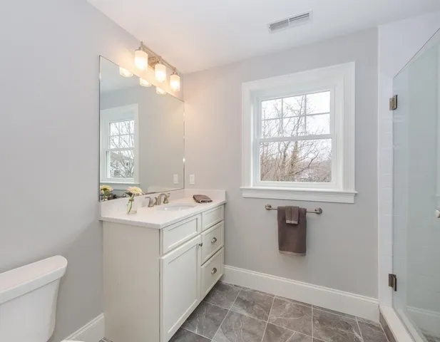 a bathroom with a sink toilet and mirror