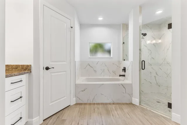 a bathroom with a bathtub and a shower