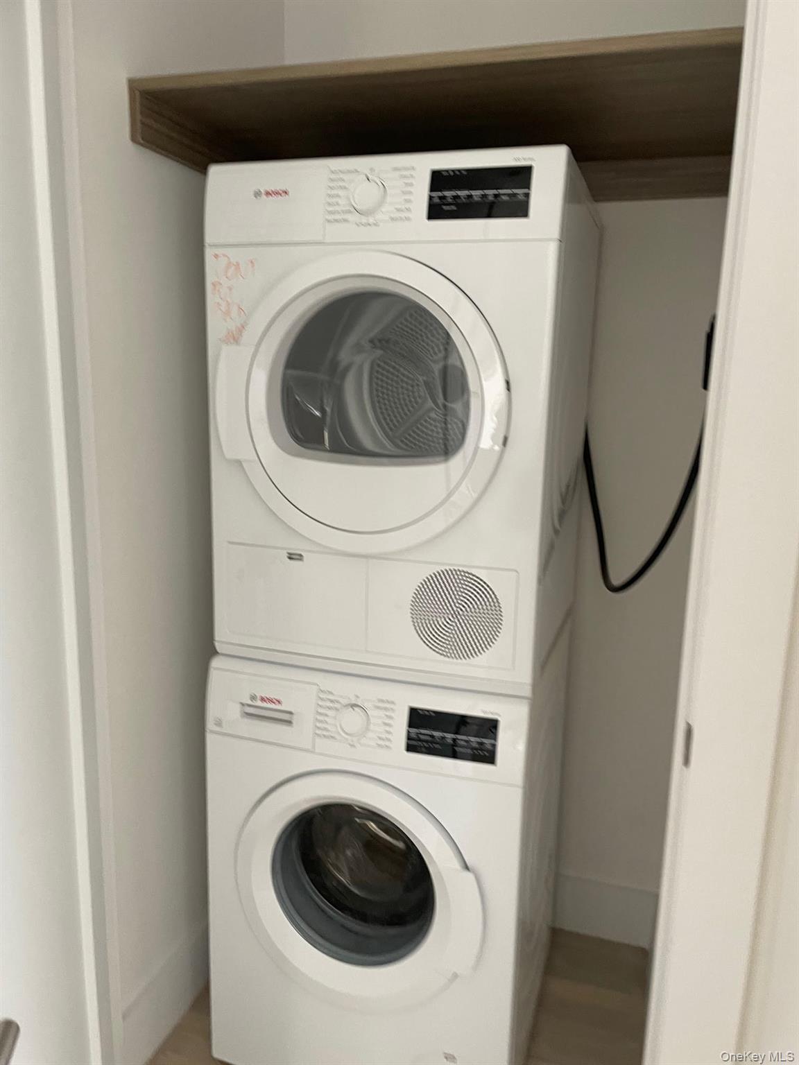 19-14 21st Road, Unit 2A Queens, NY 11105 - Photo 12 of 19 a utility room with dryer and washer