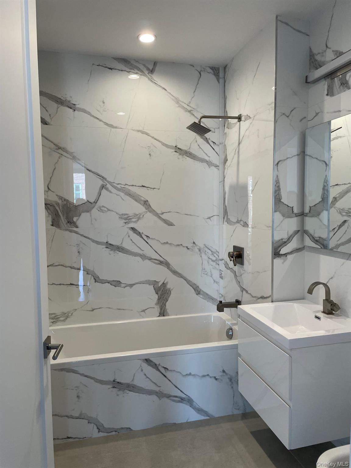 19-14 21st Road, Unit 2A Queens, NY 11105 - Photo 14 of 19 a bathroom with a bathtub and shower