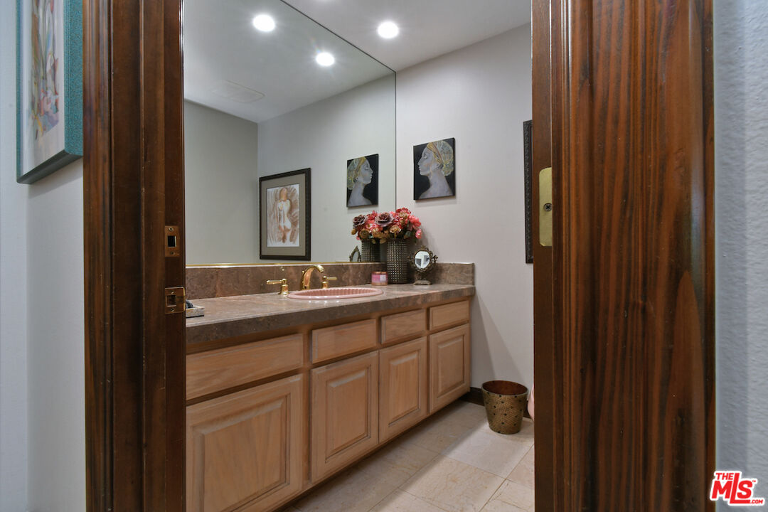 2317 Sierra Creek Road Agoura Hills, CA 91301 - Photo 26 of 73 a bathroom with a double vanity sink and a mirror