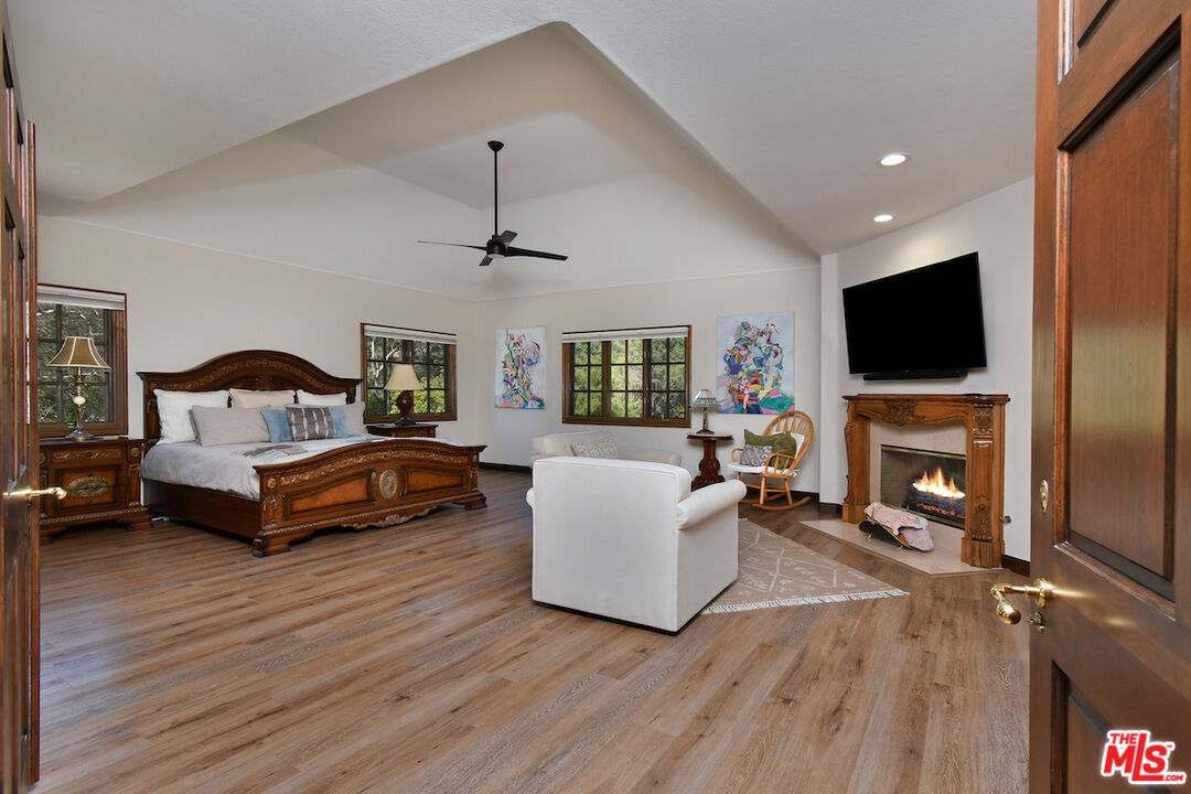 2317 Sierra Creek Road Agoura Hills, CA 91301 - Photo 38 of 73 a bedroom with furniture and a fireplace