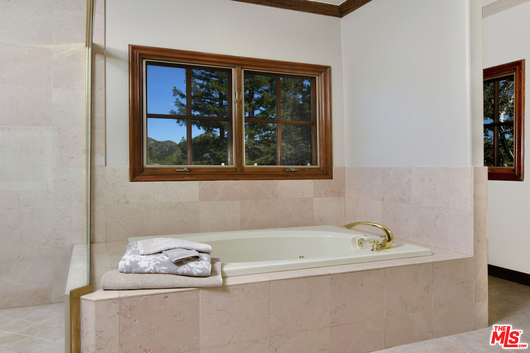 2317 Sierra Creek Road Agoura Hills, CA 91301 - Photo 45 of 73 a white bath tub sitting next to a window