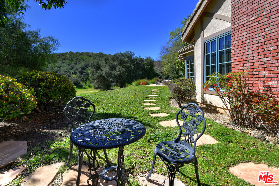 2317 Sierra Creek Road Agoura Hills, CA 91301 - Photo 63 of 73 a view of a chairs and table in a backyard